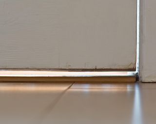 Drafty door - Light showing through gaps around badly fitting wooden exterior door