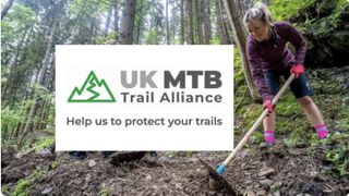 UK MTB Trail Alliance logo and woman digging trails