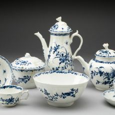 A white and blue floral tea set sitting on a gray background