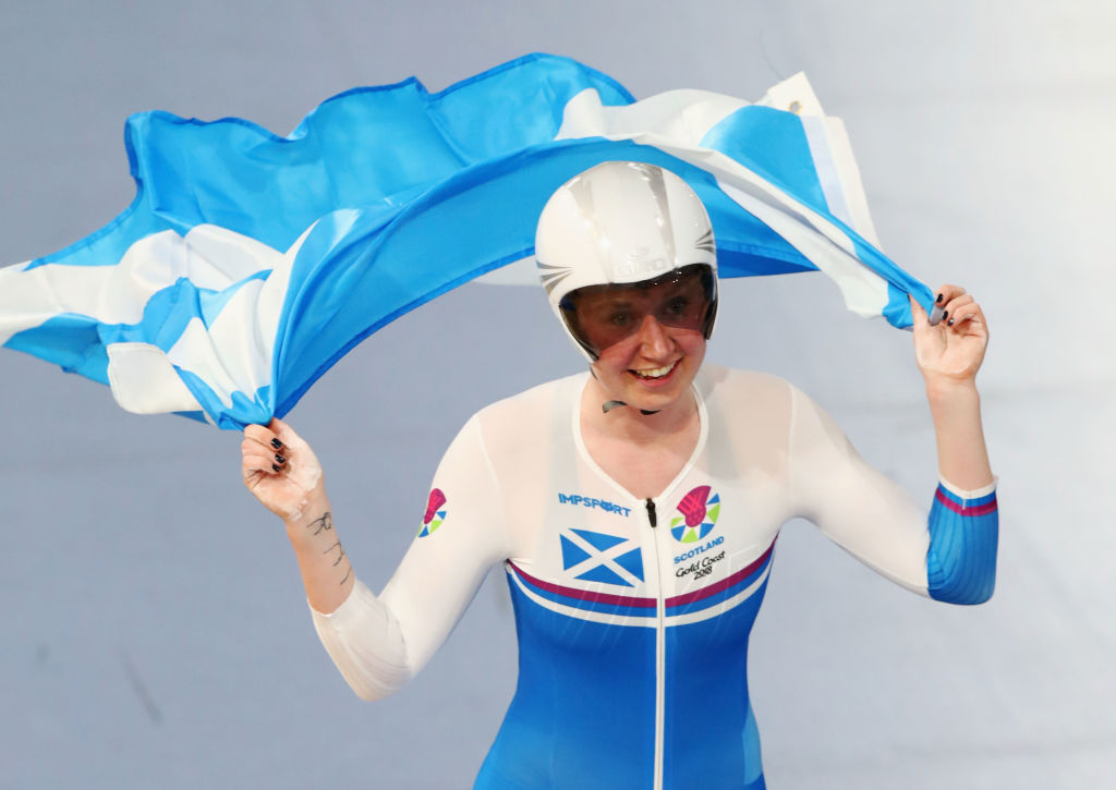 Archibald holds the Scottish flag in both hands after winning at the 2018 the Commonwealth Games