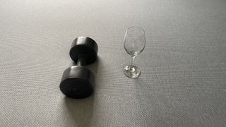 Zoma Mattress review drop test, using a weight and an empty wine glass to test motion isolation