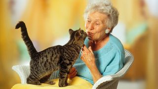 Old lady talking to cat