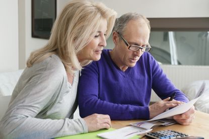 Couple examining and discussing bills