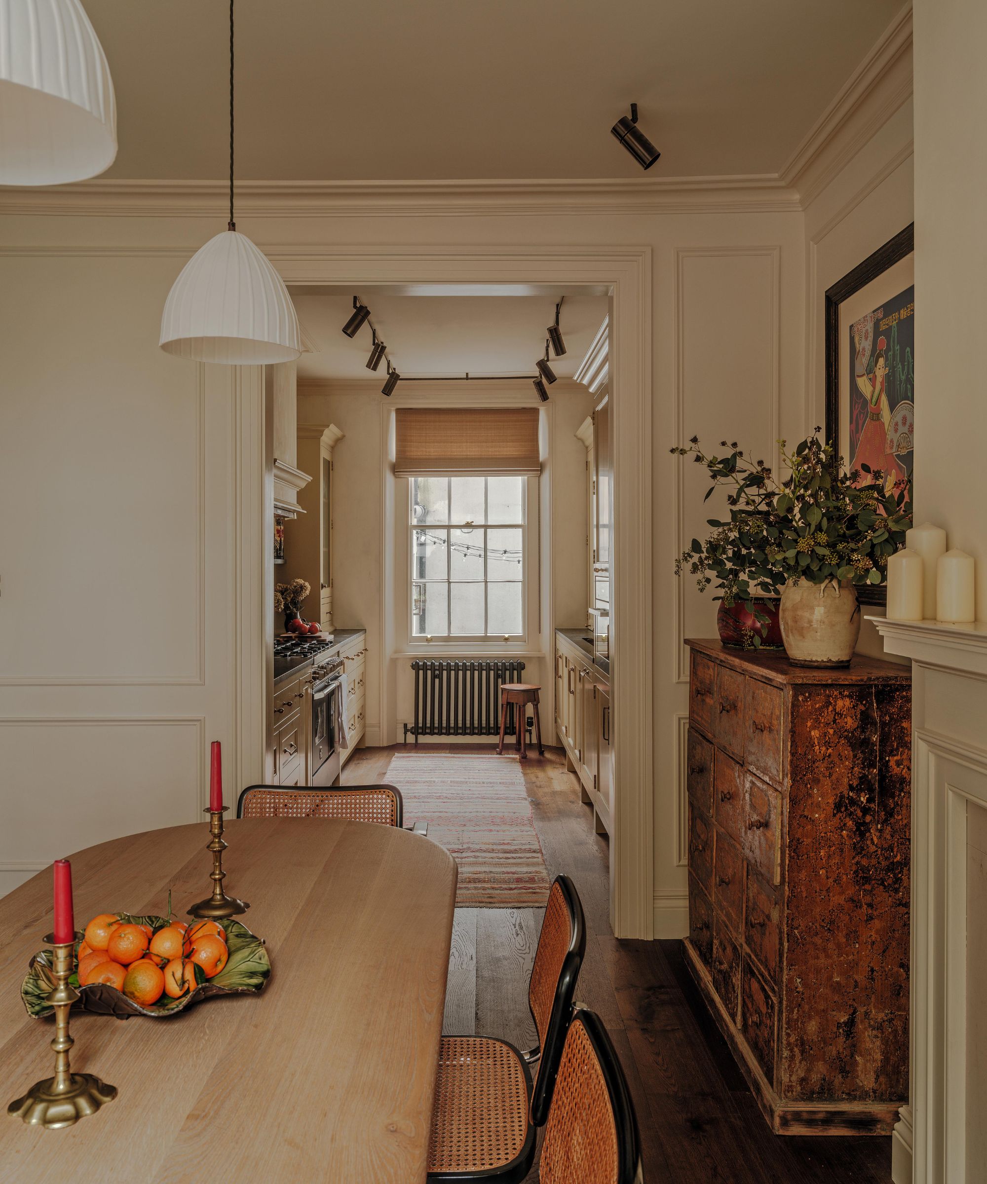 a neutral london townhouse with a view through to a galley kitchen