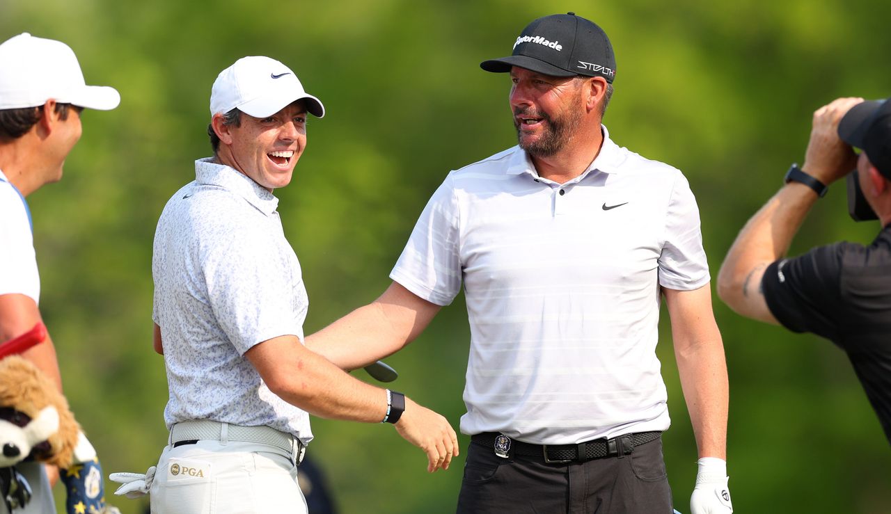 Rory McIlroy and Michael Block celebrate a hole in one 