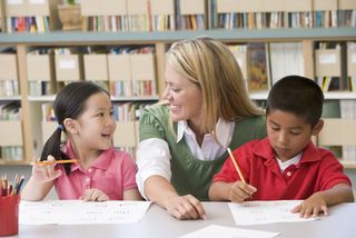 a teacher helping students