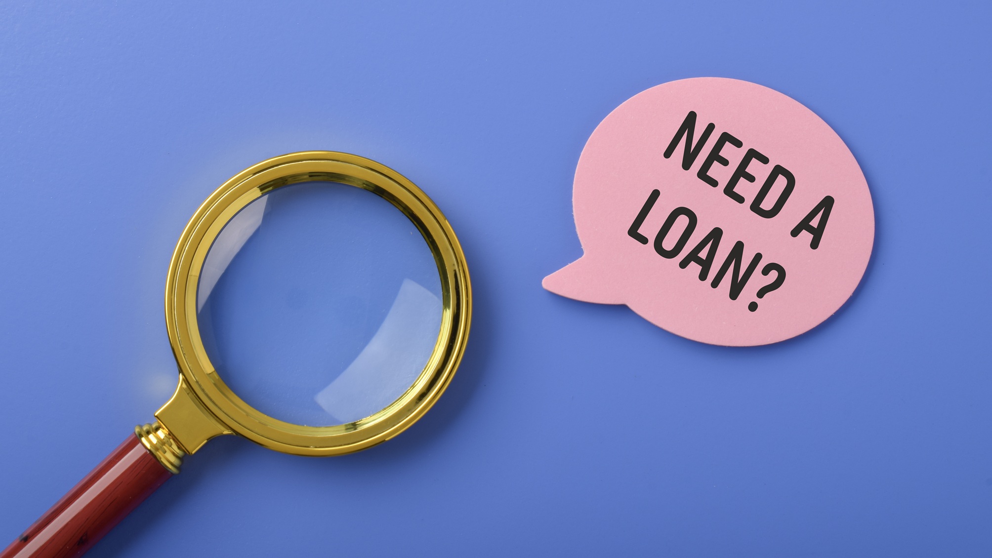 A magnifying glass next to a dialogue bubble that says, "Need a loan?"