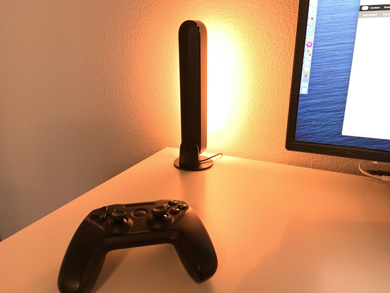 Philips Hue Play Bar dispaying orange color on a desk