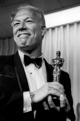 George Kennedy holding his Oscar