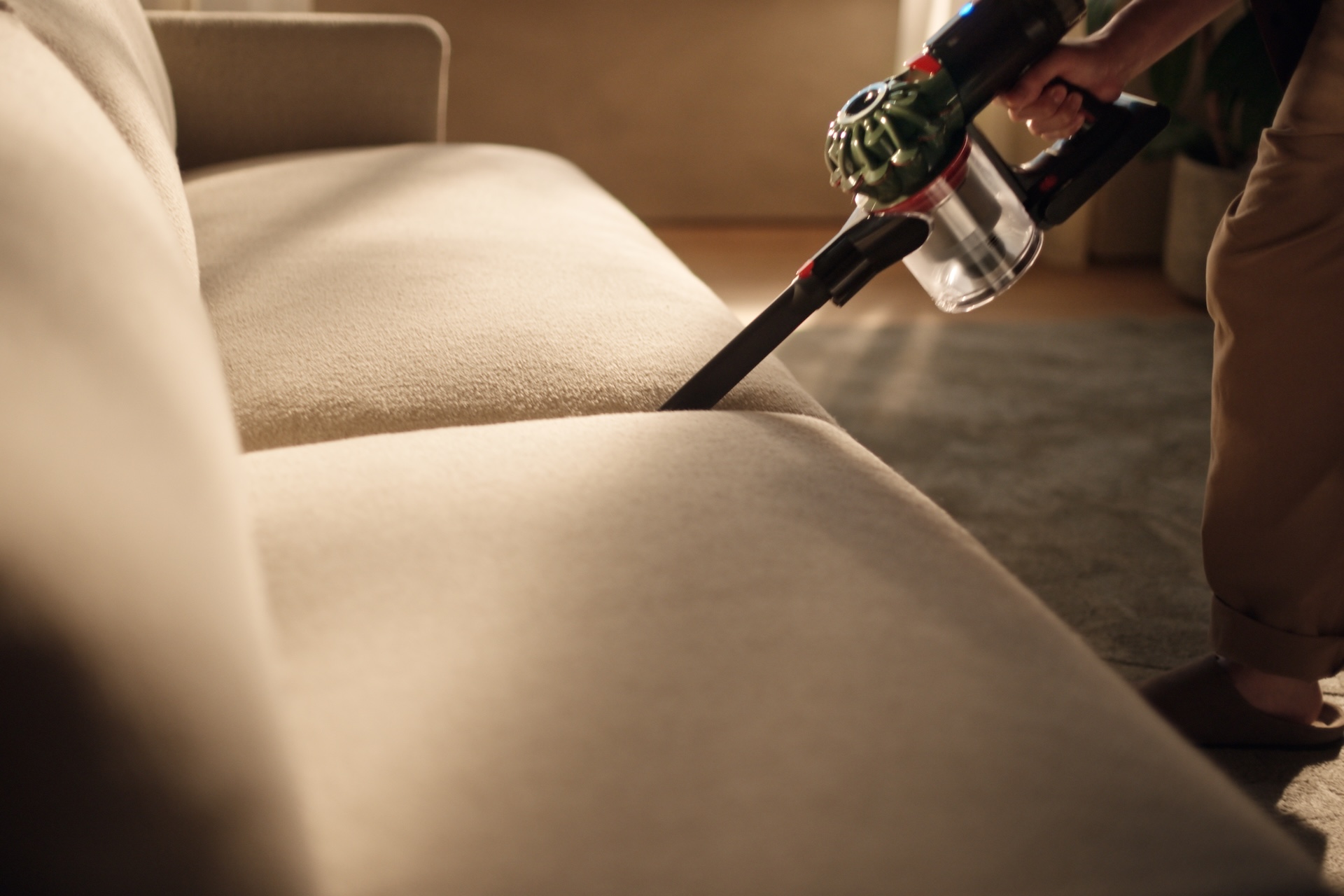 Dyson V8 Cyclone being used on a sofa