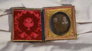 A daguerreotype on an off-white fabric background