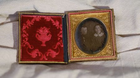 A daguerreotype on an off-white fabric background