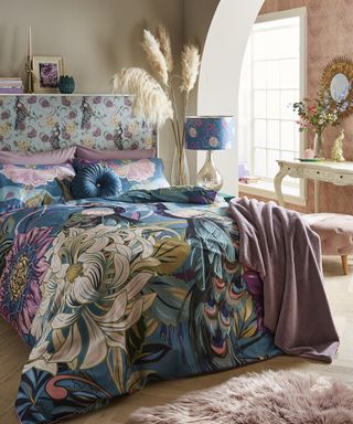 Peacock print bedding and wall decor in bedroom by Joe Brown