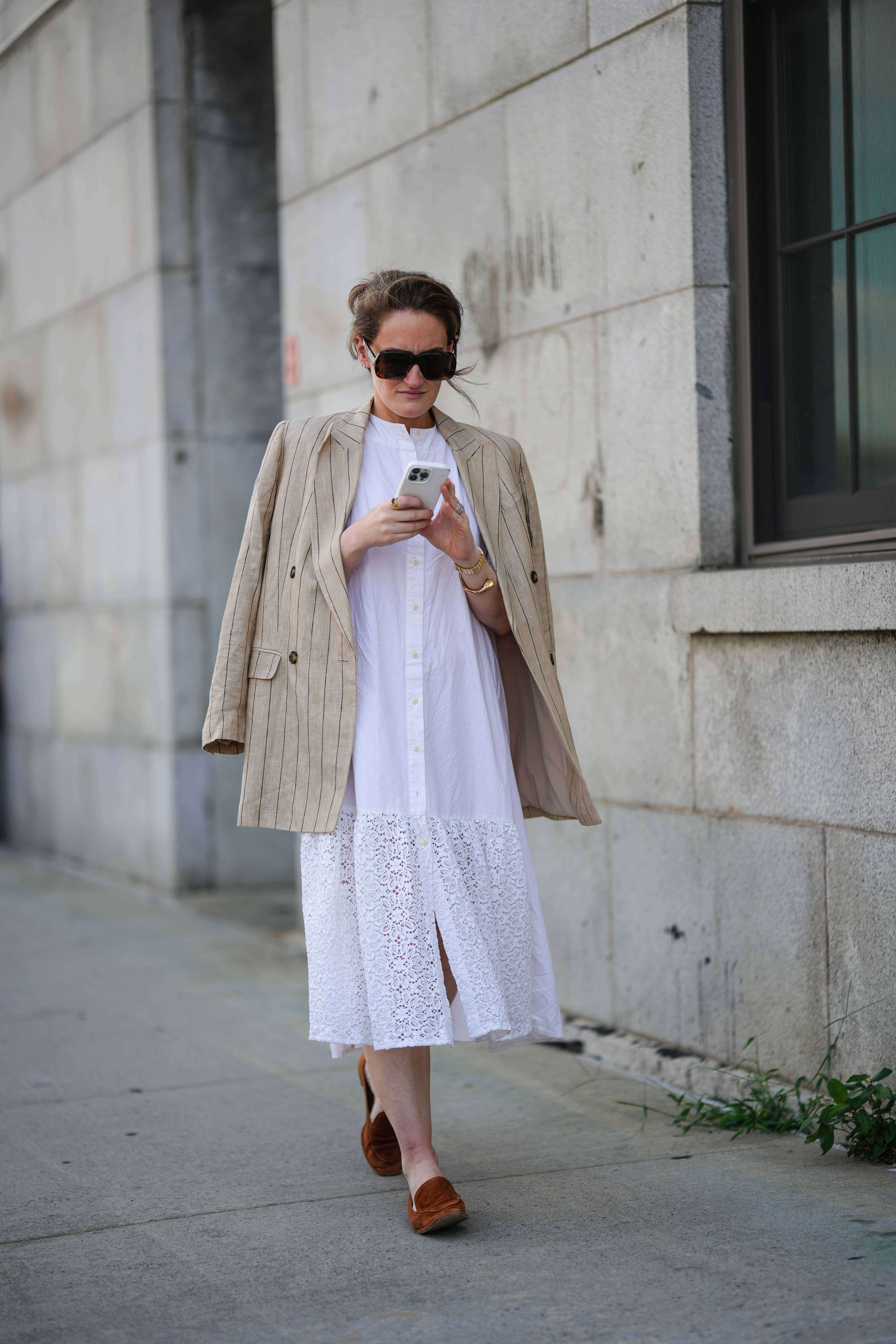woman wearing a white shirt dress and a blazer