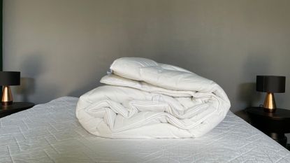 The White Company Hypoallergenic Topper unboxed on the bed