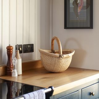 Rustic kitchen with wooden worktops and rattan basket.