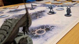 A monster stalks player characters in the Monster Hunter World Iceborne board game