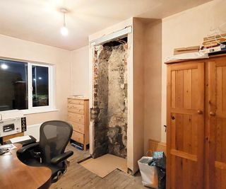 chimney breast with bricks removed and steel lintel at top