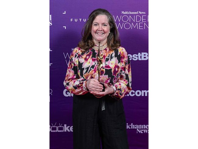 Kate O&rsquo;Brian, president, Scripps News, with her Wonder Women trophy.