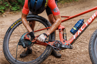 Lauren De Crescenzo stops to repair her chain during 2024 Chequamegon MTB