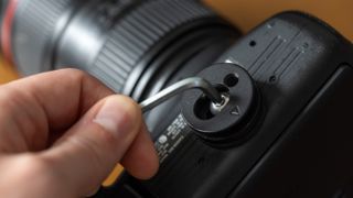 Cotton Carrier CCS Hub being attached to a camera with a hex wrench