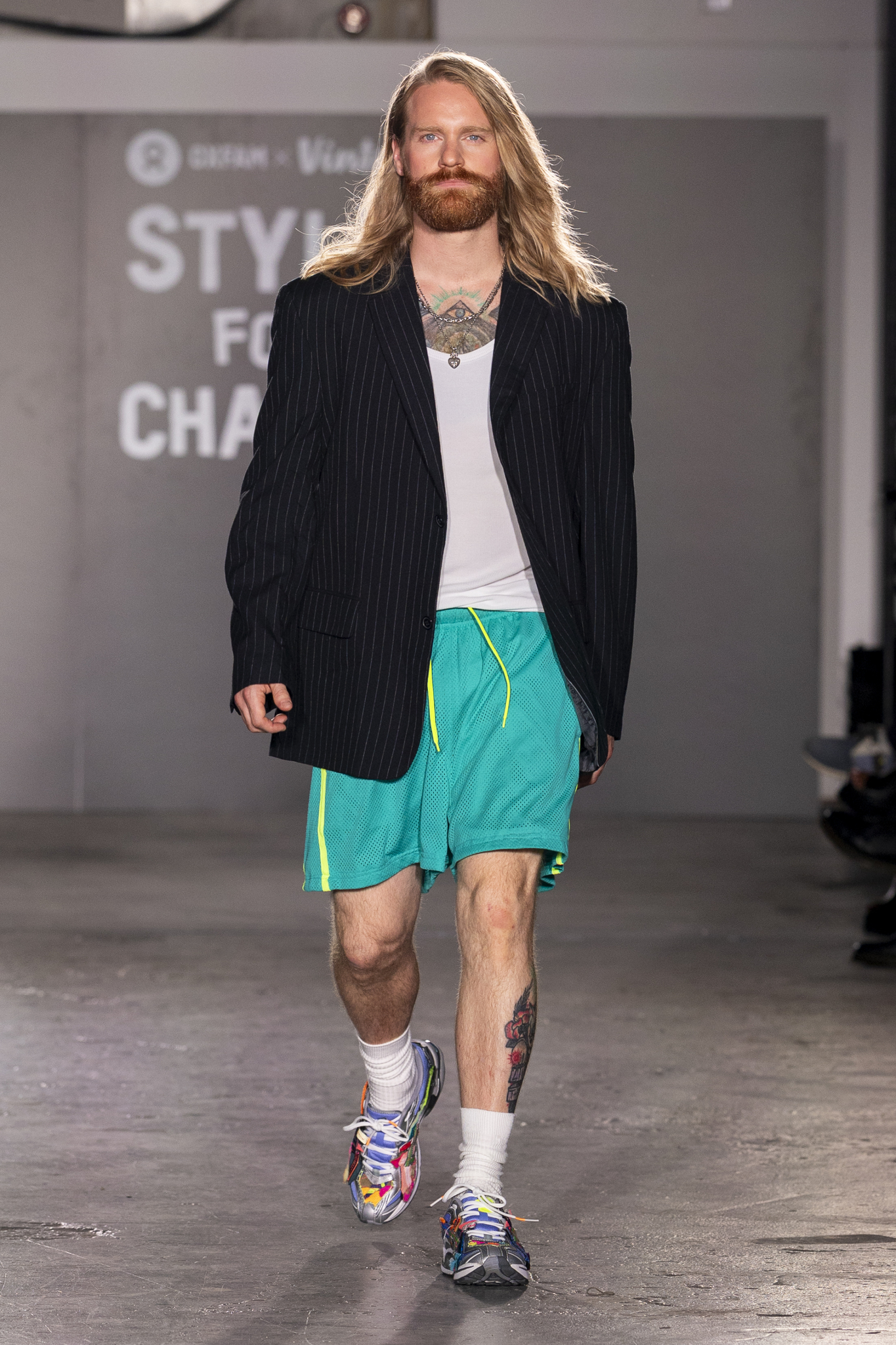 A man walking down the runway at the Oxfam London Fashion Week show