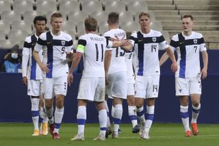 Onni Valakari, second right, is congratulated by team-mates after his goal