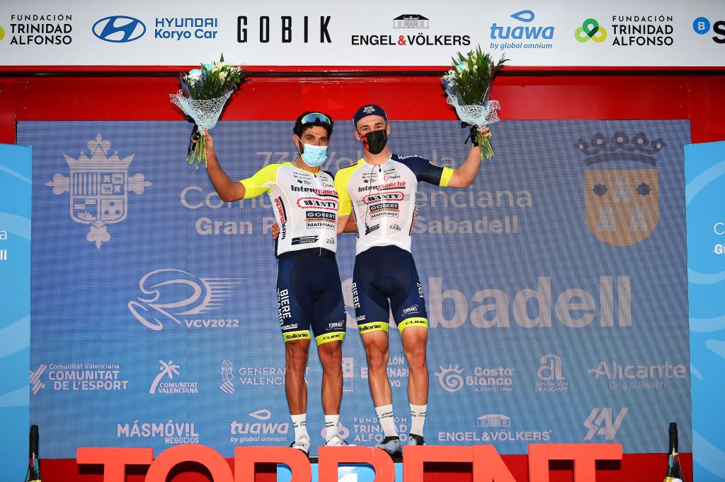 TORRENT SPAIN FEBRUARY 03 LR Andrea Pasqualon of Italy and Barnabas Pek of Hungary and Team Intermarch Wanty Gobert Matriaux celebrates at podium as best team prize during the 73rd Volta A La Comunitat Valenciana 2022 Stage 2 a 1715km stage from Btera to Torrent VCV2022 on February 03 2022 in Torrent Spain Photo by Dario BelingheriGetty Images