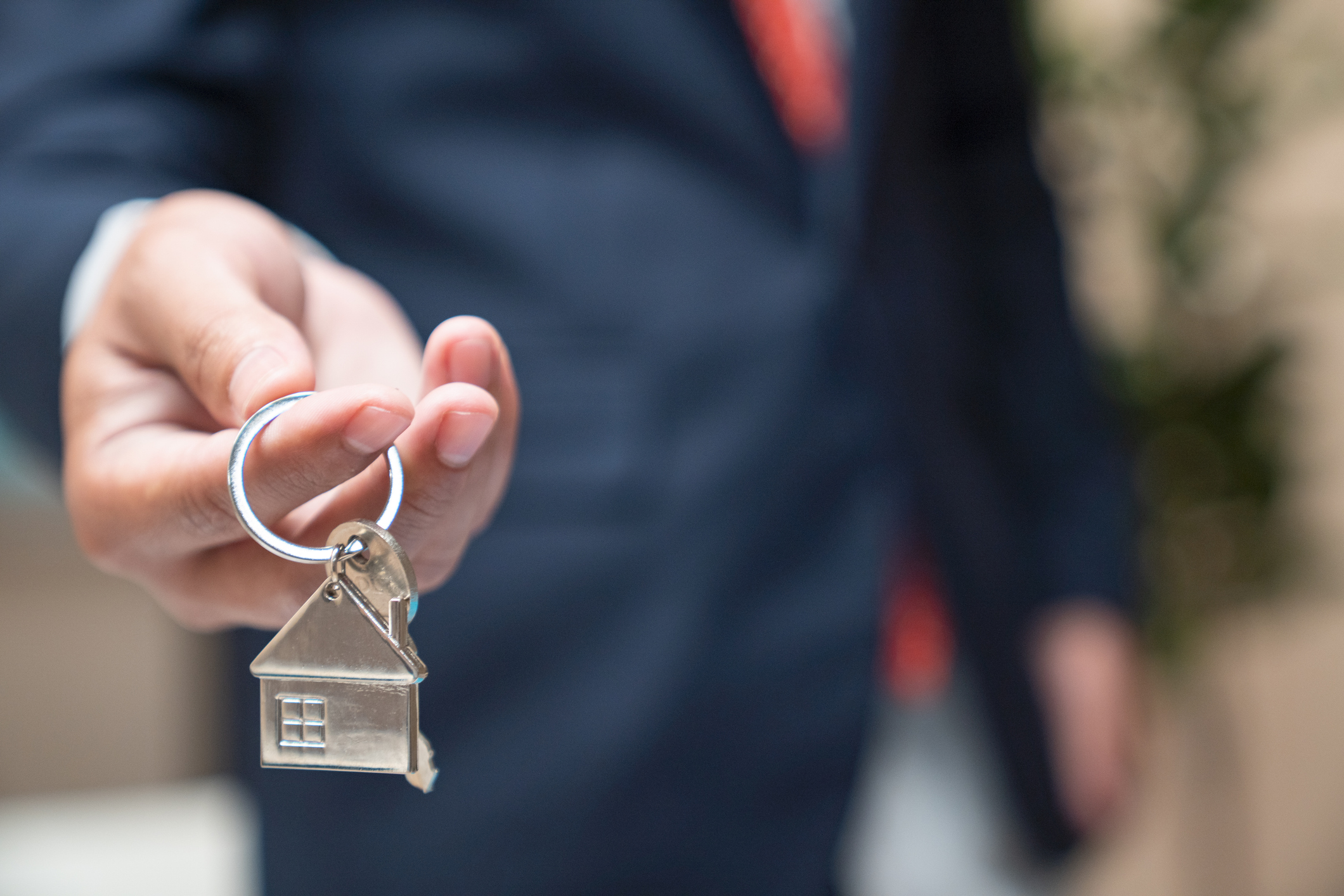 Real estate agent holding a home key