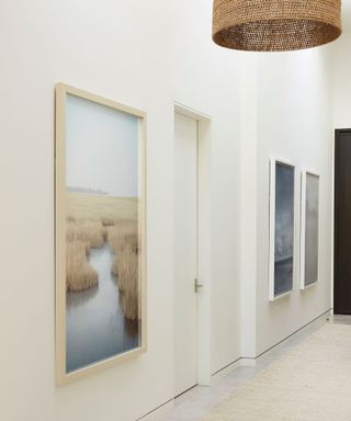 Narrow entryway with white walls and large artwork