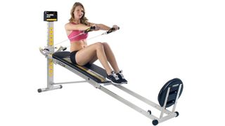 Total Gym FIT review: An image showing a woman using the glideboard system to exercise her arms