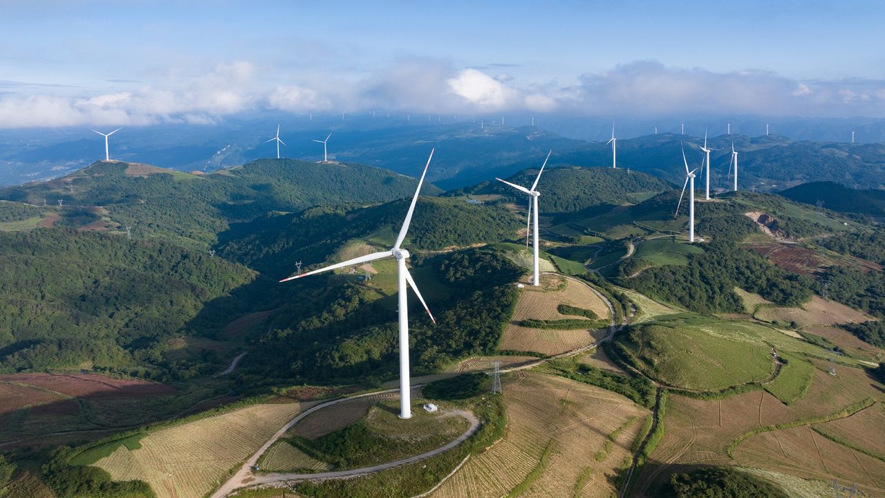 Wind turbines rotate at a mountain wind farm in Yichang, China.