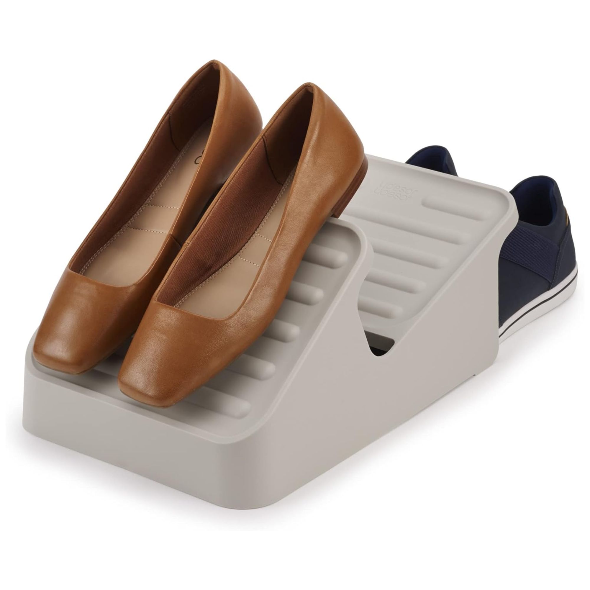 A grey shoe organizer with two pairs of shoes on it.