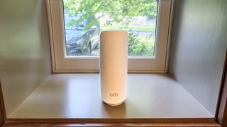 Netgear Orbi 370 mesh router on a windowsill
