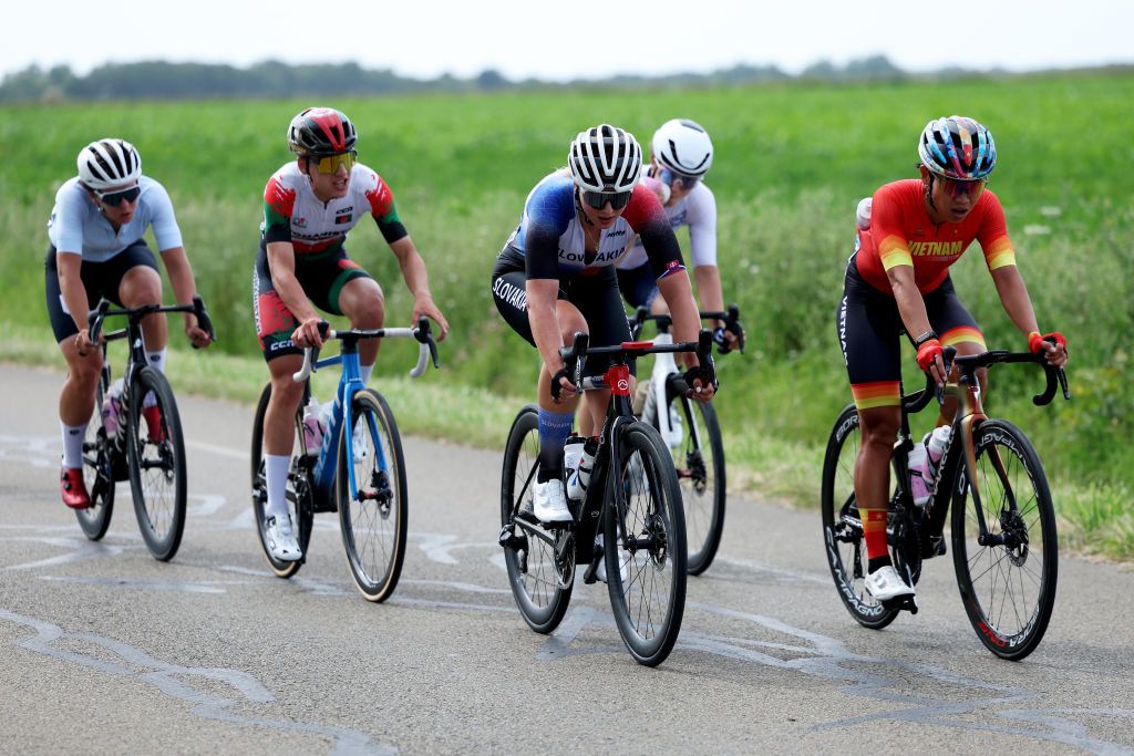 PARIS FRANCE AUGUST 04 LR Hanna Tserakh of Team Individual Neutral Athletes Fariba Hashimi of Team Afghanistan Nora Jencusova of Team Slovakia and Thi That Nguyen of Team Vietnam compete in the breakaway during the Womens Road Race on day nine of the Olympic Games Paris 2024 at Trocadero on August 04 2024 in Paris France Photo by Alex BroadwayGetty Images