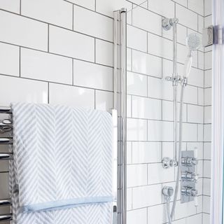 bathroom with white tiles and shower