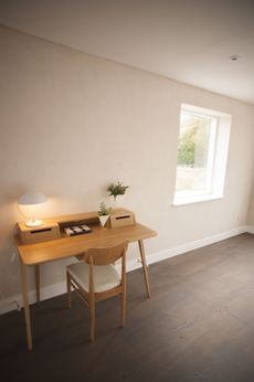 lime plastered room with a modernist desk