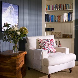 living room with book shelf and arm chair