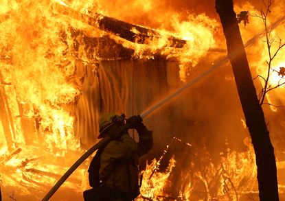 Firefighter battles blaze in northern California.