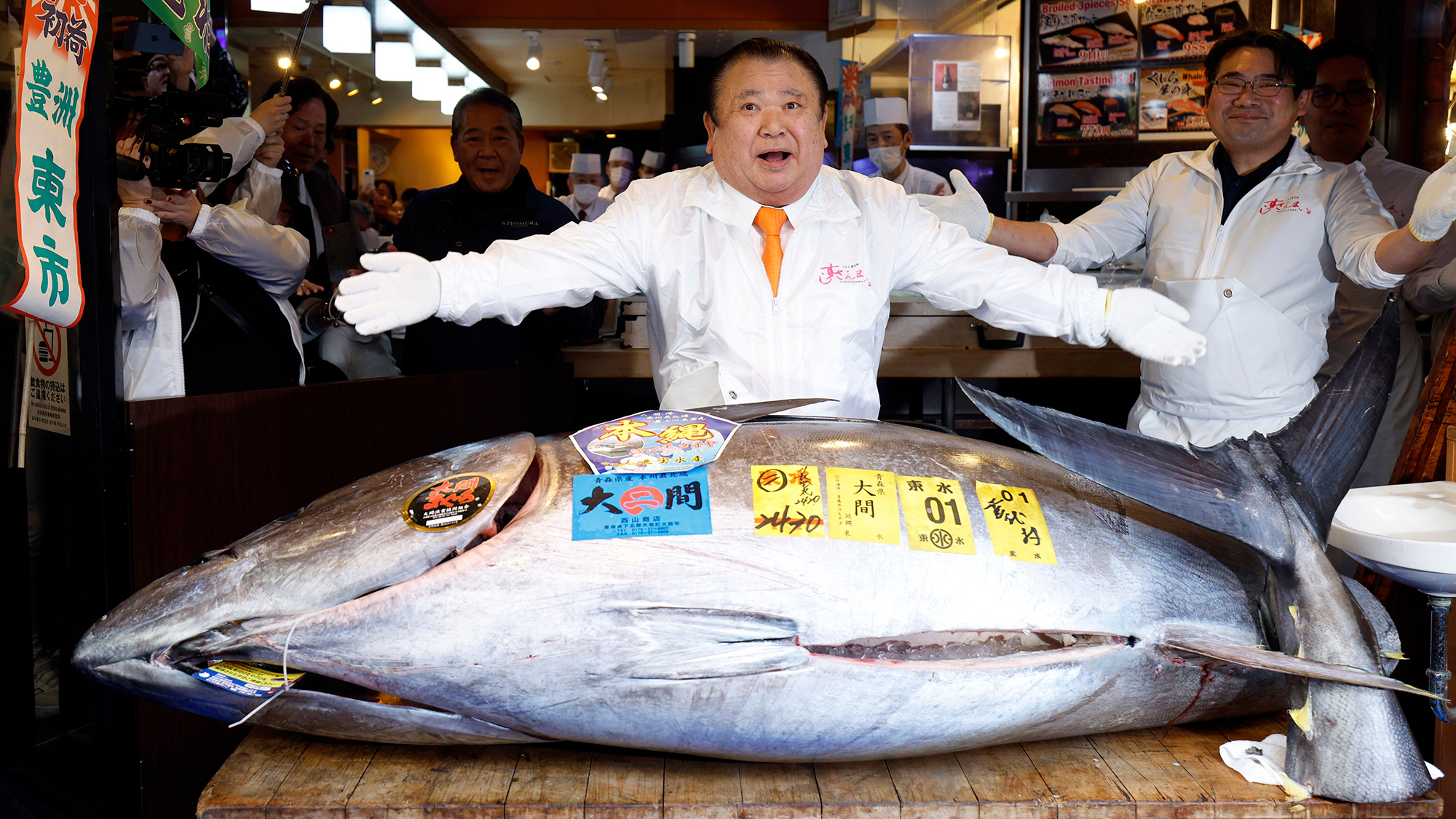Sushizanmai president Kiyoshi Kimura gestures before the 243-kilogram bluefin tuna he auctioned at a record price of 510 million yen (around $3.2 million) in Tokyo, Japan