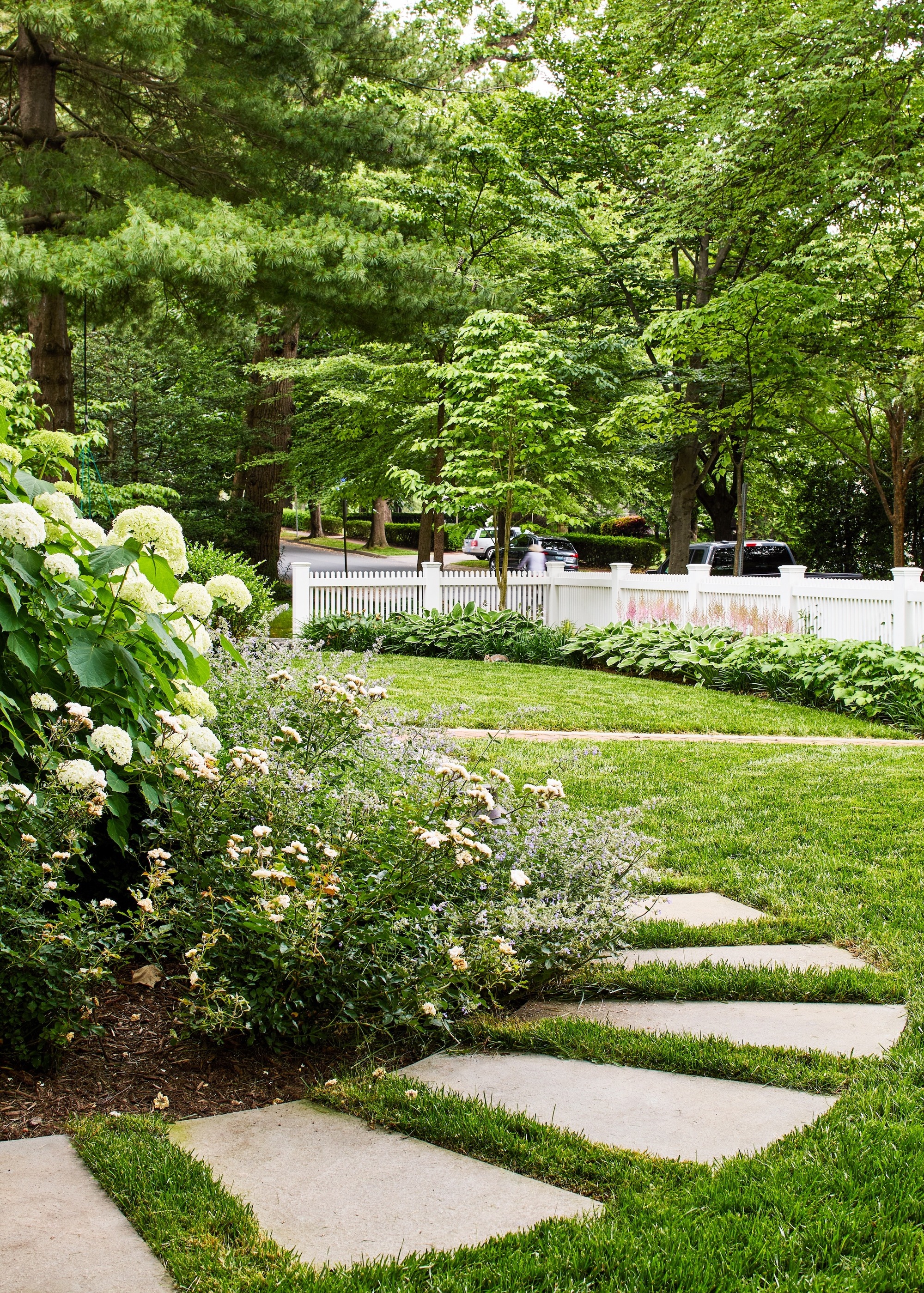 garden path created with spaced textured slabs beside a flower bed