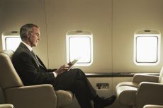 Business man travelling aboard a private jet