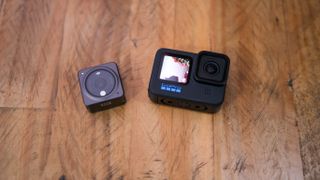 A photo of the GoPro Hero10 Black next to the DJI Action 2
