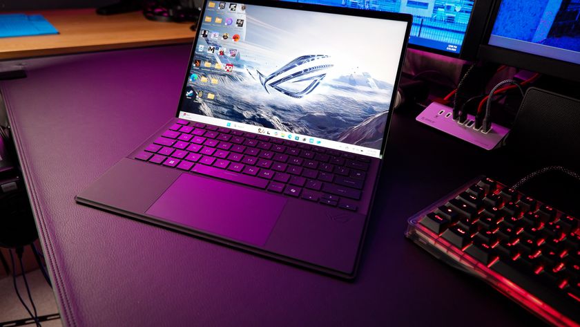 An ROG Flow Z13 (2025) set up on a desk with the detachable keyboard and charger.