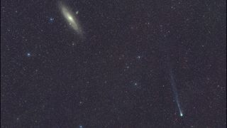 a bright, fuzzy dot can be seen among a background of stars, leaving a wispy trail behind it