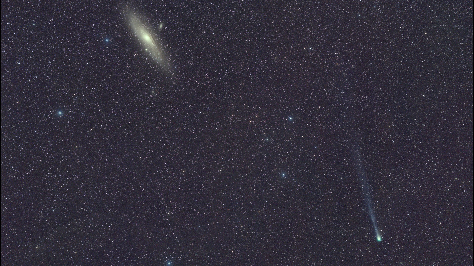 a bright, fuzzy dot can be seen among a background of stars, leaving a wispy trail behind it