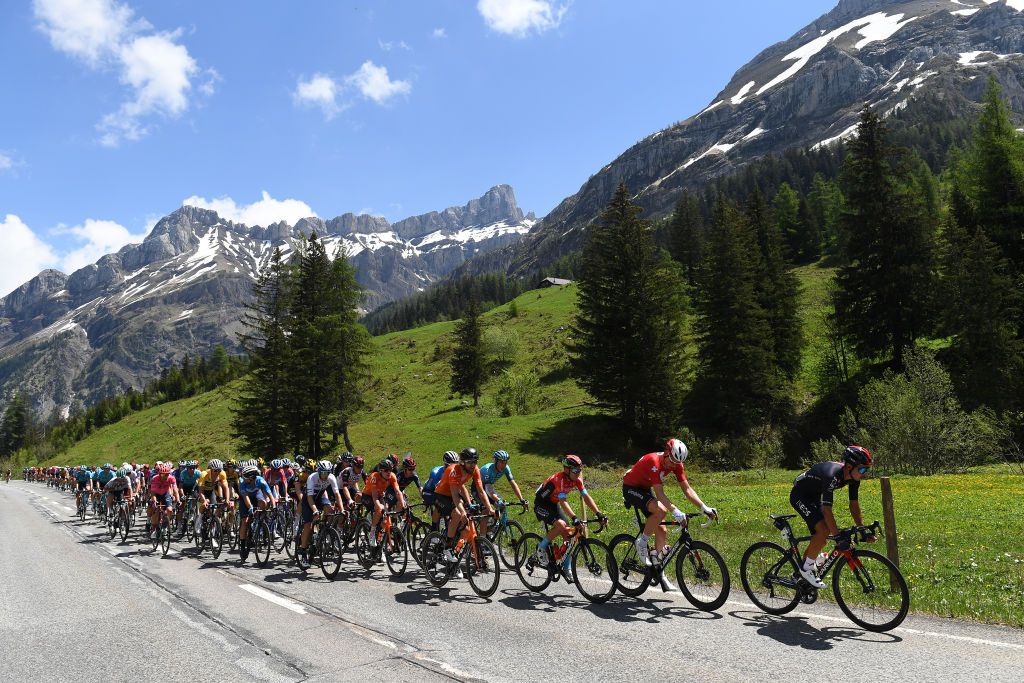 LEUKERBAD SWITZERLAND JUNE 10 Sebastian Henao Gomez of Colombia and Team INEOS Grenadiers Stefan Kng of Switzerland and Team Groupama FDJ Hermann Pernsteiner of Austria and Team Bahrain Victorious Kyle Murphy of United States and Team Rally Cycling The peloton passing through Col du Pillon 1546m mountain landscape during the 84th Tour de Suisse 2021 Stage 5 a 1752km stage from Gstaad to Leukerbad 1385m Mountains Snow UCIworldtour tds tourdesuisse on June 10 2021 in Leukerbad Switzerland Photo by Tim de WaeleGetty Images