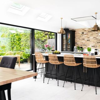 open plan kitchen with island unit, sliding doors and skylight windows