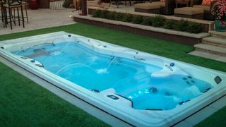 Michael Phelps Swim Spa review: An image of a Michael Phelps pool surrounded by a green lawn