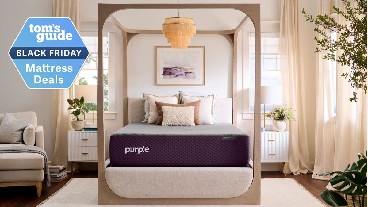 Purple cooling mattress deals in Black Friday sales in light beige bedroom with four poster bedframe, plants, white bedside tables and nude curtains